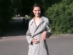 Amazing dark brown A cute adolescent Russian of legal age shows off her assets outside while wearing a coat.